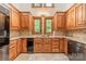 Functional kitchen with wooden cabinetry, granite countertops, and tiled backsplash at 4509 Rosecliff Dr, Charlotte, NC 28277