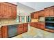 Spacious kitchen with custom cabinetry, granite countertops, stainless appliances, and light tile floors at 4509 Rosecliff Dr, Charlotte, NC 28277