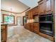 Bright kitchen with stone tile floors, wood cabinets, granite countertops, and stainless steel appliances at 4509 Rosecliff Dr, Charlotte, NC 28277