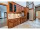 Charming kitchen featuring granite counters, tiled backsplash, warm wood cabinetry, and stainless appliances at 4509 Rosecliff Dr, Charlotte, NC 28277