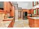 Gorgeous kitchen with custom cabinets, granite counters, travertine tile floor, stainless refrigerator, and gas cooktop at 4509 Rosecliff Dr, Charlotte, NC 28277