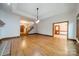 Bright and airy living room with hardwood floors, staircase, and access to other areas at 4509 Rosecliff Dr, Charlotte, NC 28277