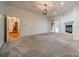 Spacious carpeted living room with a fireplace, access to stairs and an outdoor patio at 4509 Rosecliff Dr, Charlotte, NC 28277