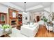 Elegant living room features a brick fireplace, hardwood floors, lots of natural light, and comfortable seating at 4509 Rosecliff Dr, Charlotte, NC 28277