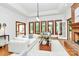 Bright living room with a brick fireplace, large windows, hardwood floors, and comfortable seating at 4509 Rosecliff Dr, Charlotte, NC 28277