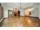 Spacious living room features hardwood floors, a brick fireplace, and access to other rooms at 4509 Rosecliff Dr, Charlotte, NC 28277