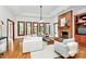 Spacious living room featuring a brick fireplace, large windows, hardwood floors, and a comfortable seating arrangement at 4509 Rosecliff Dr, Charlotte, NC 28277