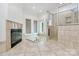 Bright primary bathroom featuring a fireplace, tiled bathtub, and tiled shower with glass door at 4509 Rosecliff Dr, Charlotte, NC 28277