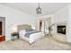 Main bedroom featuring a fireplace, a door to the screened in porch, and neutral colors at 4509 Rosecliff Dr, Charlotte, NC 28277
