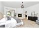 Main bedroom with fireplace, dark wood dresser, and French doors leading to a sunroom at 4509 Rosecliff Dr, Charlotte, NC 28277