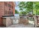 Outdoor kitchen featuring stainless steel appliances, bar seating, and tile counters at 4509 Rosecliff Dr, Charlotte, NC 28277