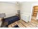 Bedroom with chair and small bed, complimented by wood-look flooring at 5014 Oxford School Rd, Claremont, NC 28610