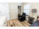 Bedroom featuring chair and small bed, complemented by wood-look flooring at 5014 Oxford School Rd, Claremont, NC 28610
