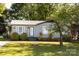 Charming single-story home with mature trees, tidy landscaping, and a light gray exterior at 5014 Oxford School Rd, Claremont, NC 28610