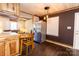 Kitchen with stainless steel refrigerator and breakfast table with seamless transition into the living room at 5014 Oxford School Rd, Claremont, NC 28610