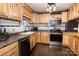 Light wood kitchen cabinets, stainless appliances, and a contrasting black backsplash at 5014 Oxford School Rd, Claremont, NC 28610