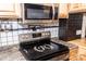 Stainless steel stove and microwave with light wooden cabinets and unique backsplash at 5014 Oxford School Rd, Claremont, NC 28610
