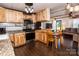 Cozy kitchen with light wood cabinets, stainless appliances, and a breakfast table with seating at 5014 Oxford School Rd, Claremont, NC 28610