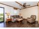 Comfortable living room featuring hardwood floors, neutral paint, exposed beams, and ample natural light at 5014 Oxford School Rd, Claremont, NC 28610