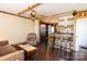 Inviting open-concept living space with wood beams, hardwood floors, and a seamless flow to the kitchen at 5014 Oxford School Rd, Claremont, NC 28610