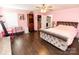 Pink bedroom with ceiling fan and closet showcases a comfortable bed and charming décor at 5014 Oxford School Rd, Claremont, NC 28610