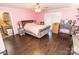 Sunlit bedroom with hardwood floors showcases large bed, closet, and access to the laundry room at 5014 Oxford School Rd, Claremont, NC 28610