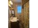 Cozy bathroom with a single vanity, window, and patterned shower curtain at 515 Benton St, Monroe, NC 28110