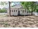 Back of house featuring sunroom, tidy lawn and a classic white picket fence at 531 Walnut St, Statesville, NC 28677