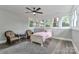Bedroom featuring three windows, wood floors, and neutral paint at 531 Walnut St, Statesville, NC 28677