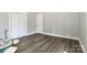 Minimalist bedroom with gray vinyl plank flooring, white trim, and closet at 531 Walnut St, Statesville, NC 28677