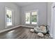 Bright bedroom featuring two windows and modern gray vinyl plank flooring at 531 Walnut St, Statesville, NC 28677