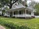 Charming home showcasing a wrap-around porch, lush greenery, and well-manicured lawn at 531 Walnut St, Statesville, NC 28677