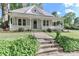 Charming home featuring a welcoming front porch and a well-maintained landscaped yard at 531 Walnut St, Statesville, NC 28677