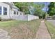 Side view of house showing landscaped yard, classic white picket fence and sidewalk at 531 Walnut St, Statesville, NC 28677