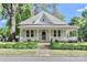 Charming single-Gathering home featuring a covered porch, dormer window, landscaped front yard, and traditional architectural details at 531 Walnut St, Statesville, NC 28677