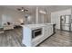 Kitchen island with quartz counters, stainless steel appliances, and open to the living room at 531 Walnut St, Statesville, NC 28677