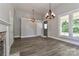 Open living room with wood floors, stylish lighting, and access to the outdoors at 531 Walnut St, Statesville, NC 28677