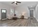 Spacious living room with neutral tones, wood-look flooring, and ample natural light at 531 Walnut St, Statesville, NC 28677