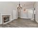 Bright living room with wood floors, stylish lighting, and fireplace at 531 Walnut St, Statesville, NC 28677