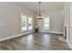 Bright living room featuring wood floors, large windows, and a vintage fireplace at 531 Walnut St, Statesville, NC 28677