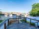 View of a backyard with a wood deck, blue shed, and white privacy fence at 541 Jetton St, Davidson, NC 28036