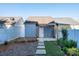 A blue shed in a backyard with stepping stones, garden beds, and a white privacy fence at 541 Jetton St, Davidson, NC 28036