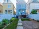 View of a backyard and blue house with stepping stones and fresh landscaping at 541 Jetton St, Davidson, NC 28036