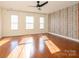 Sun-drenched bedroom with wood floors, ceiling fan, and accent wall at 541 Jetton St, Davidson, NC 28036