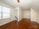 A spacious bedroom featuring wood floors, bright natural light, and white trim at 541 Jetton St, Davidson, NC 28036