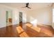A sunny, bright bedroom featuring hardwood floors and a modern ceiling fan at 541 Jetton St, Davidson, NC 28036