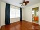 Spacious bedroom boasts hardwood floors, a ceiling fan, ample natural light, and an attached bath at 541 Jetton St, Davidson, NC 28036