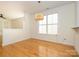 Bright dining area with hardwood floors and modern lighting, leading into the living space at 541 Jetton St, Davidson, NC 28036