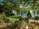 Charming home with a landscaped front yard, a white picket fence, and mature trees at 541 Jetton St, Davidson, NC 28036