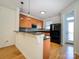 Bright kitchen features hardwood floors, a breakfast bar, granite counters, and stainless steel appliances at 541 Jetton St, Davidson, NC 28036